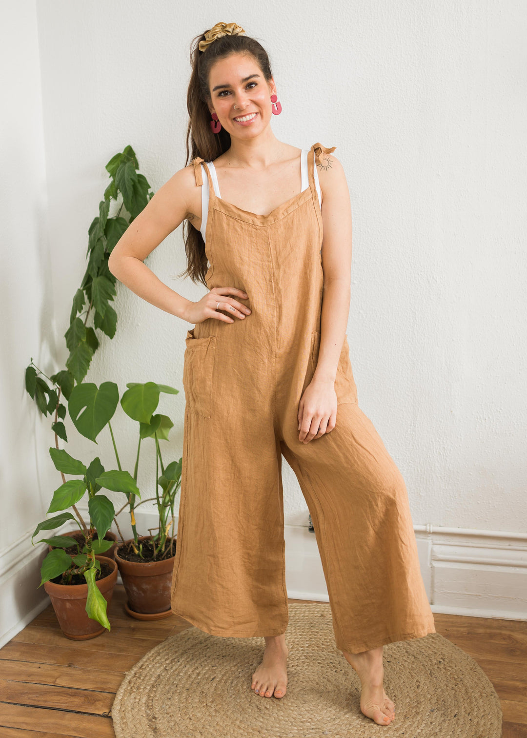 Tan linen wide leg jumpsuit with pockets and adjustable straps
